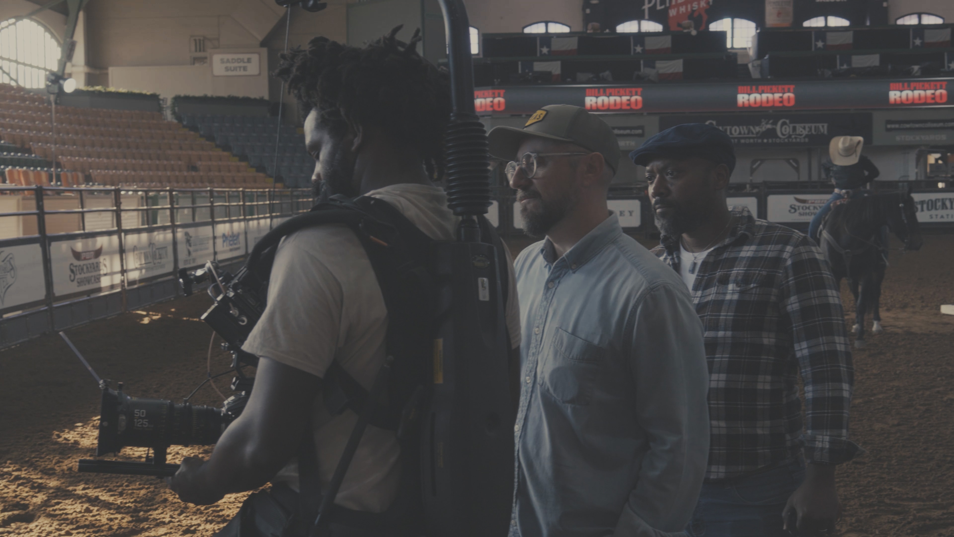 Director and crew with Steadicam operator on the Bill Pickett Rodeo floor