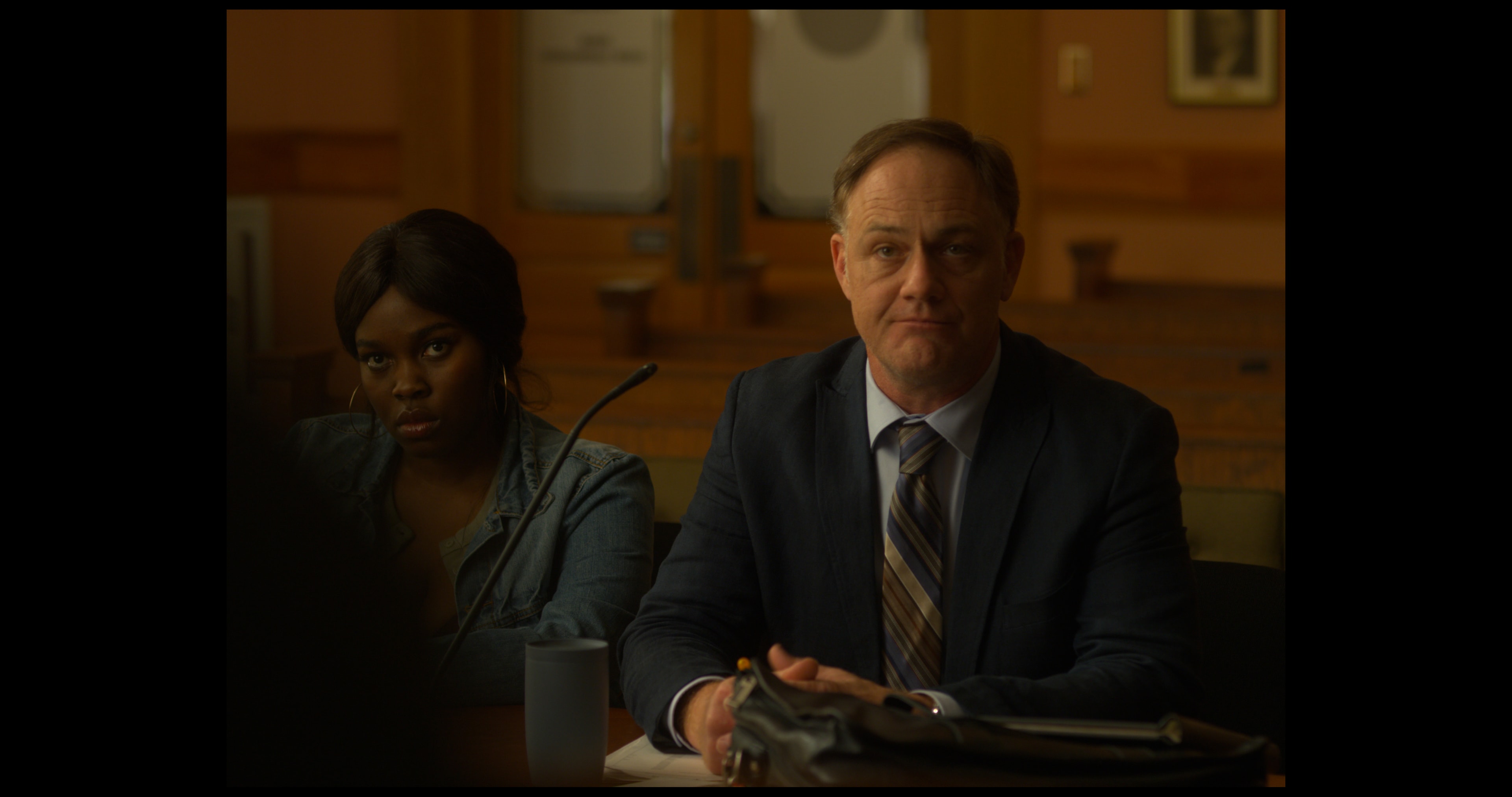 Two actors in a tense courtroom scene from Just Justice