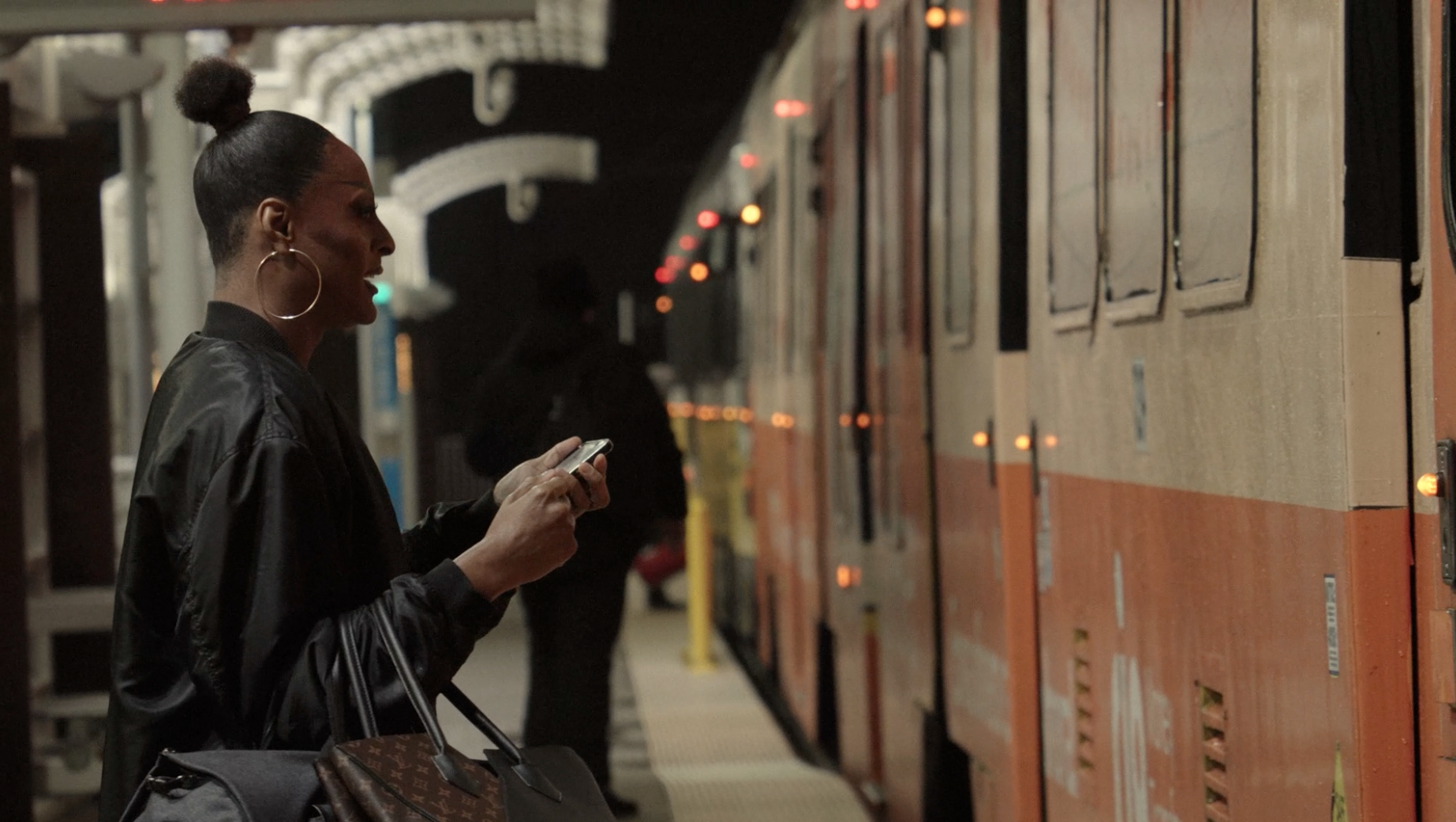 Woman waiting on subway platform at night