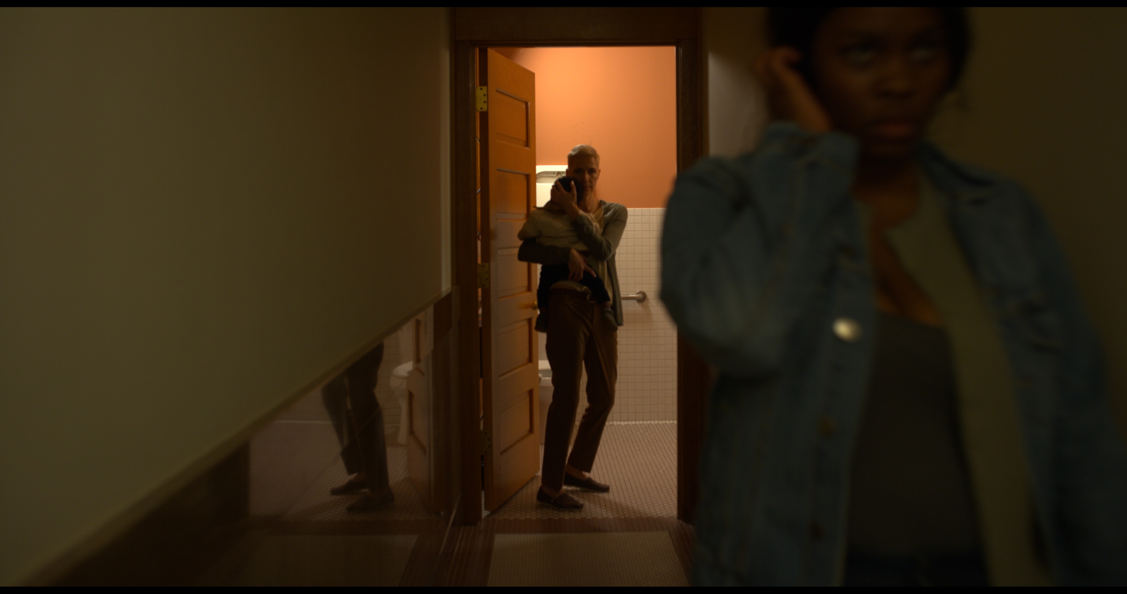 Kiersten protects JJ in a tense hallway scene