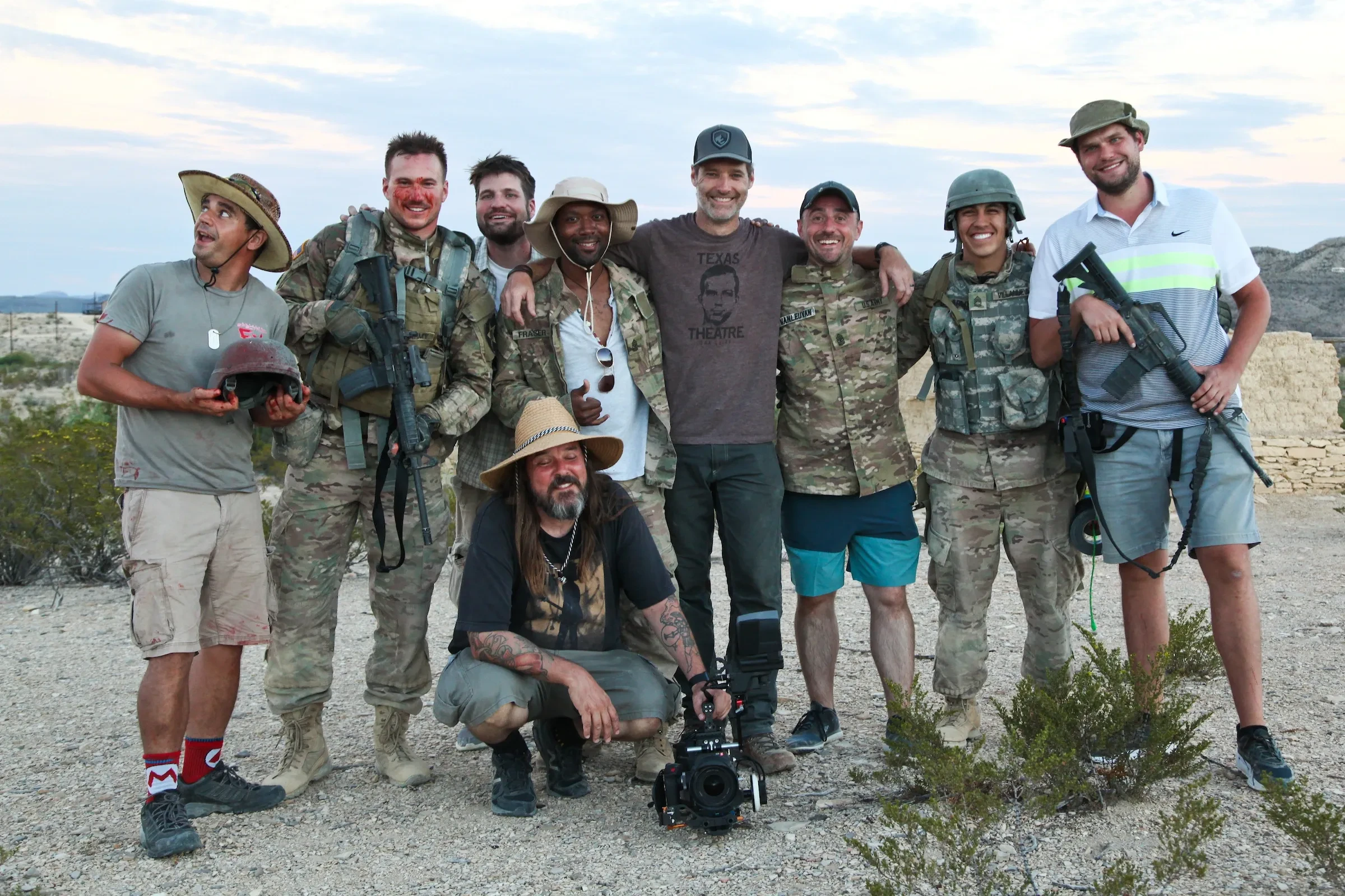 Film crew and cast in tactical gear on desert location