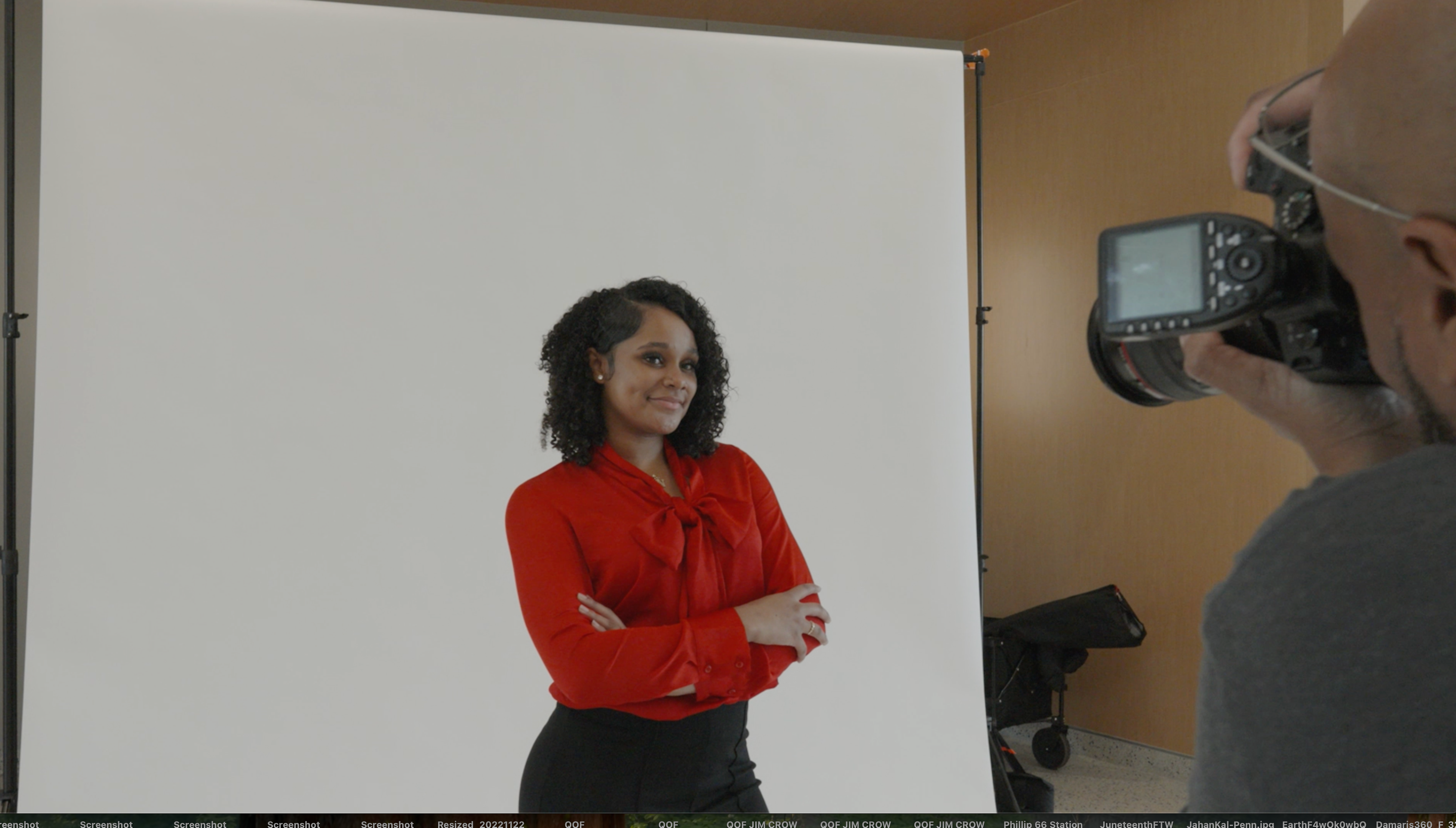 Behind-the-scenes portrait shoot with woman in red blouse