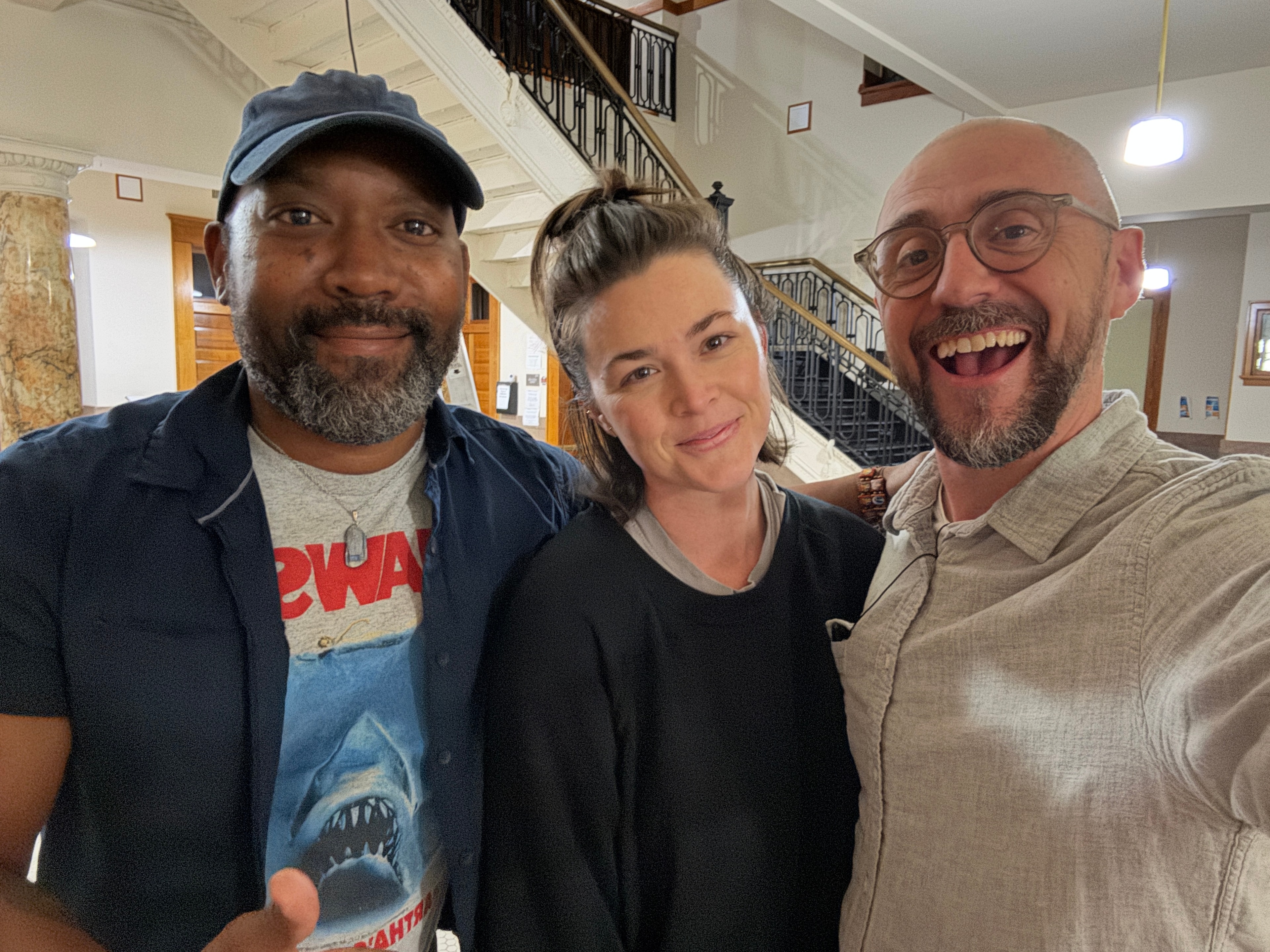 Three people smiling indoors together